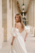 Woman wearing Monique Lhuillier Fall 2023 Bliss white strapless sweetheart BL23201 ballgown with tufted sleeves