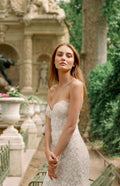 Woman wearing Monique Lhuillier Fall 2023 Bliss white lace strapless sweetheart fitted BL23202 gown with long train