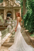 Woman wearing Monique Lhuillier Fall 2023 Bliss white lace strapless sweetheart fitted BL23202 gown with long train