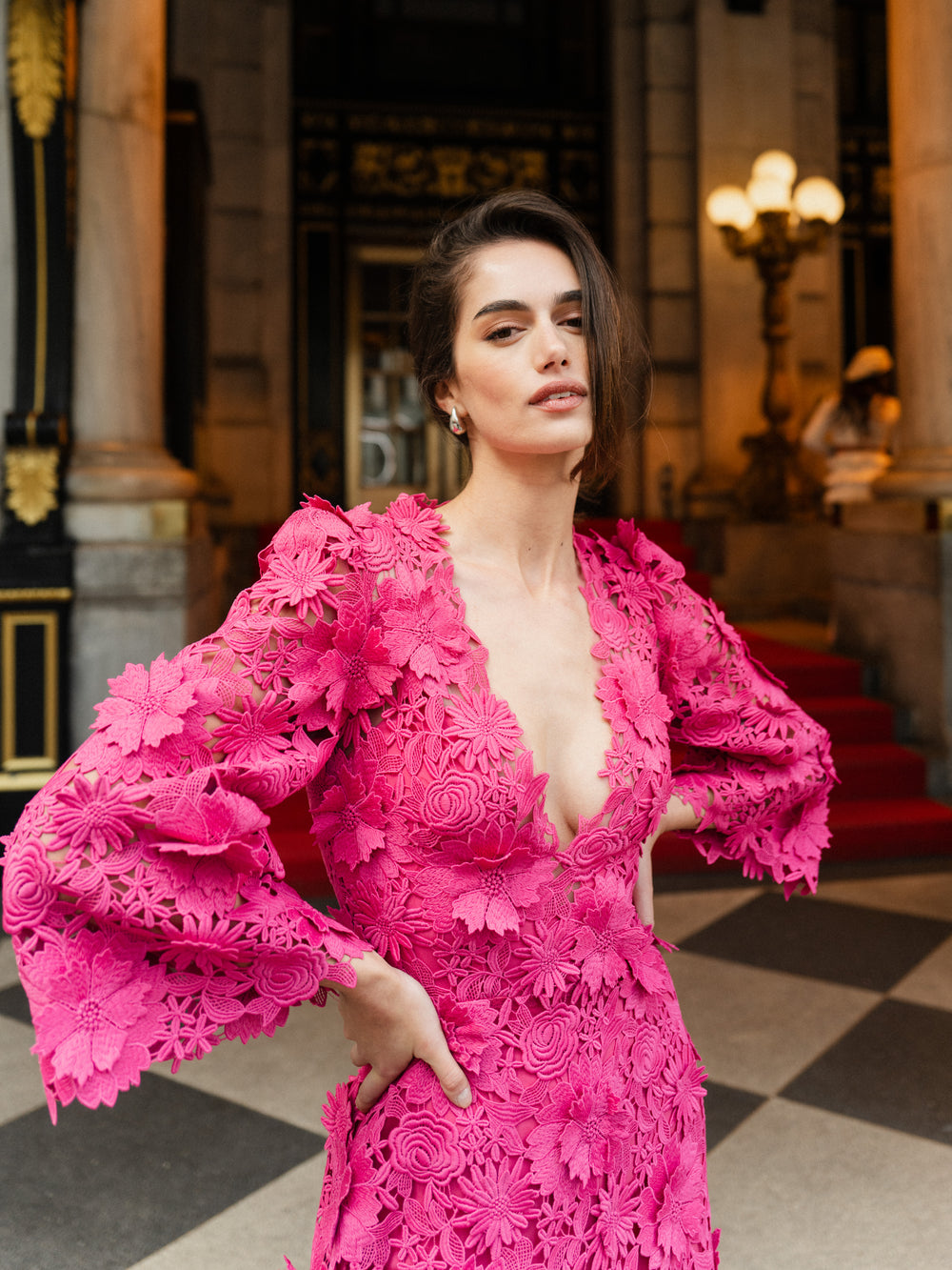 Monique Lhuillier Fall 2024 bell sleeve, floor length gown with deep v-neckline in Fuchsia 3D Guipure Lace - lookbook one.