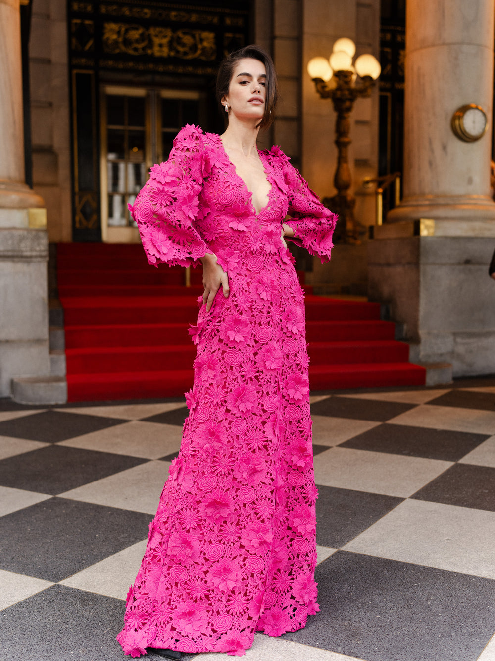 Monique Lhuillier Fall 2024 bell sleeve, floor length gown with deep v-neckline in Fuchsia 3D Guipure Lace - lookbook two.