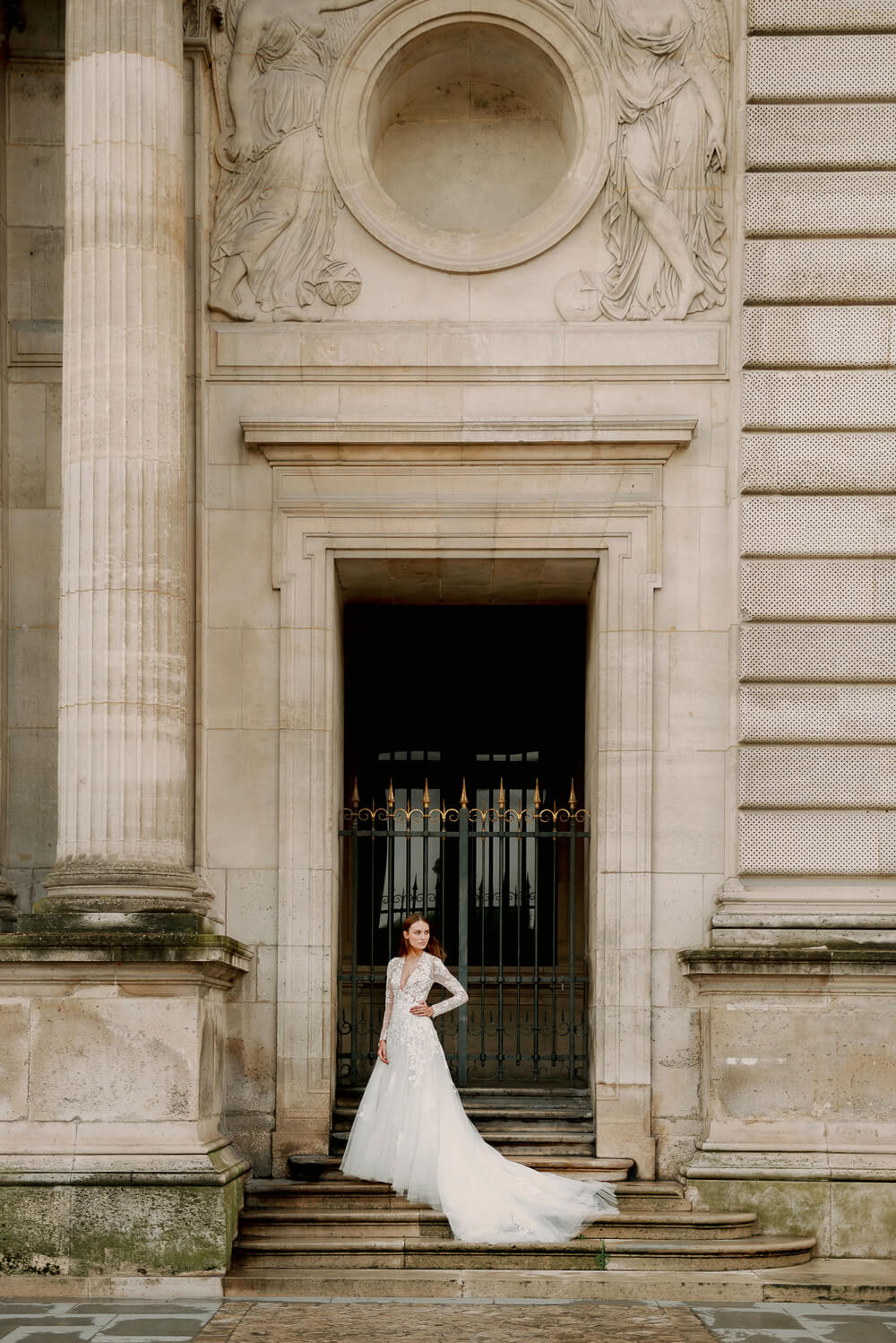 Woman wearing Monique Lhuillier Fall 2023 Bliss long sleeve v-neck white embroidered tulle a-line BL23203 gown