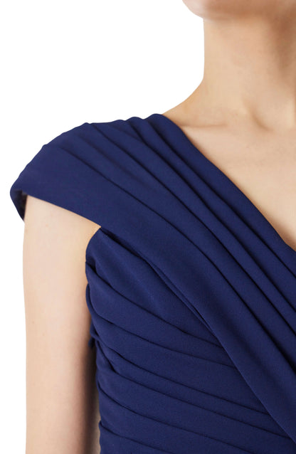 Monique Lhuillier navy gown with draped neckline and high leg slit in jersey chiffon fabric.