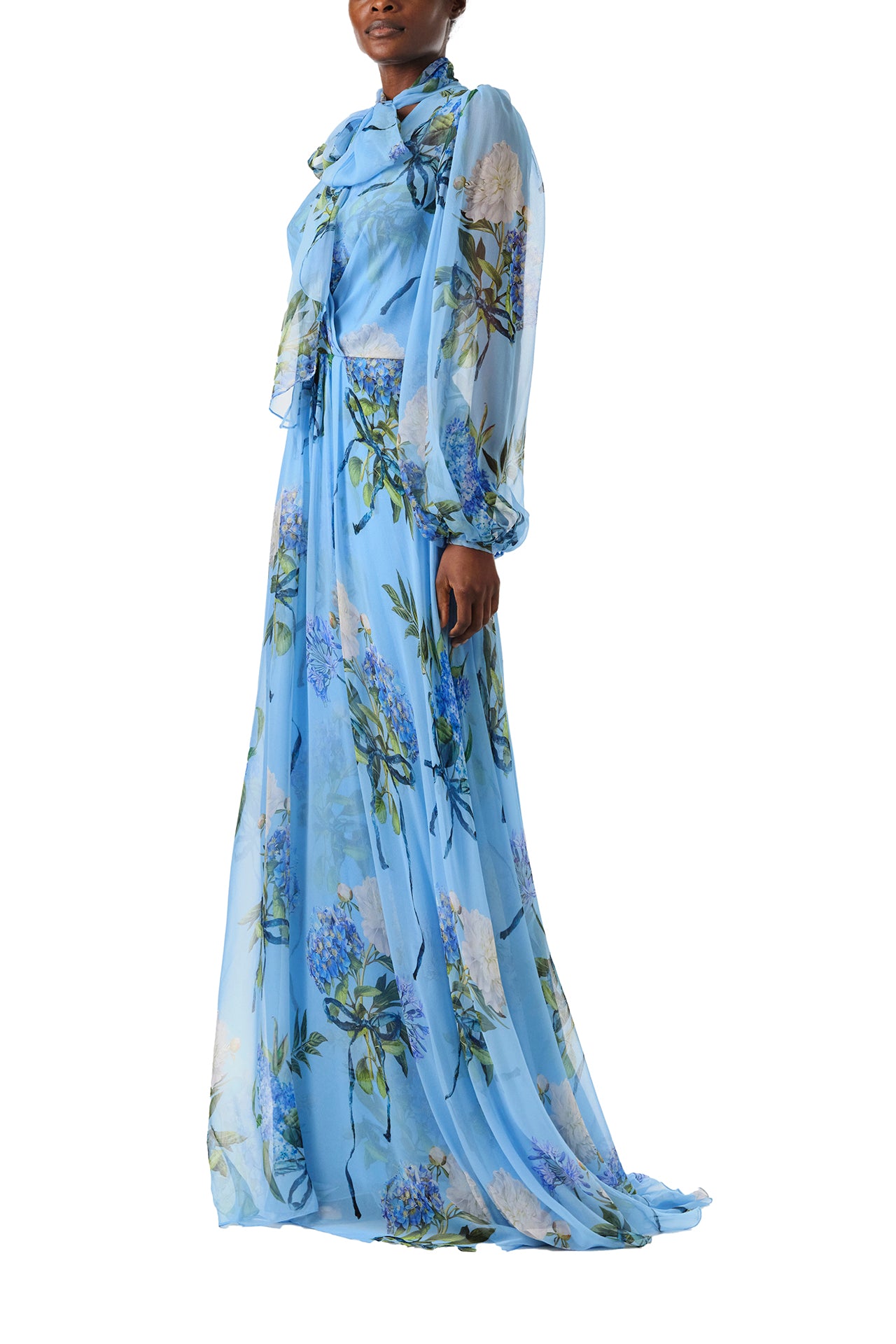 Monique Lhuillier Fall 2024 long sleeve gown in blue floral printed chiffon with self-tie neckline - left side.
