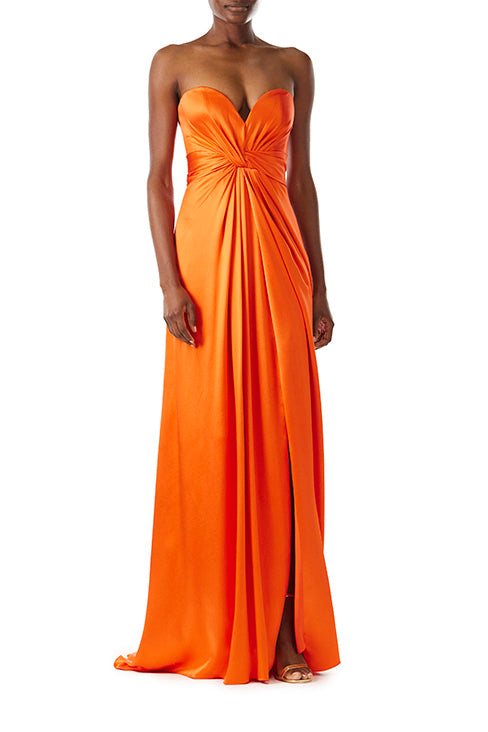 Monique Lhuillier strapless poppy red satin gown with twist bodice and high front slit.