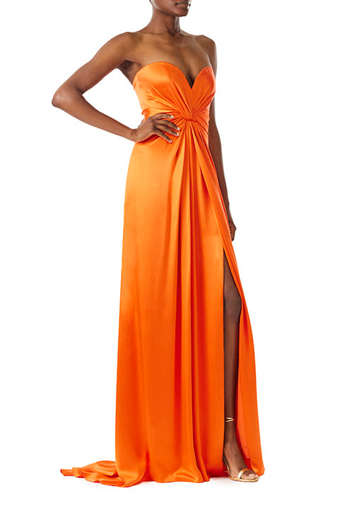 Monique Lhuillier strapless poppy red satin gown with twist bodice and high front slit.