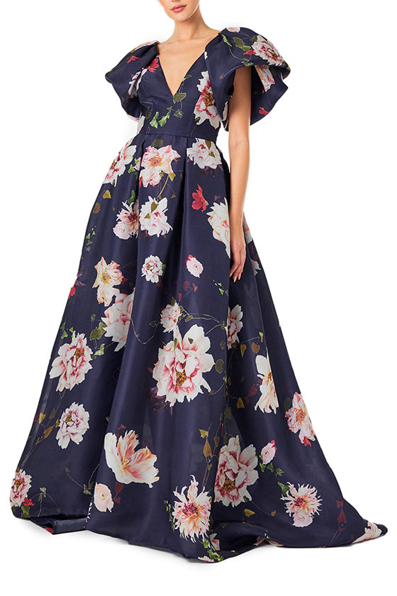 Monique Lhuillier navy floral gazar gown with deep v neckline, ruffle flutter sleeves and pockets.  