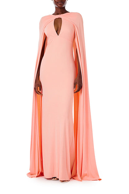 Monique Lhuillier melon colored crepe-back satin gown with attached cape and keyhole bodice.