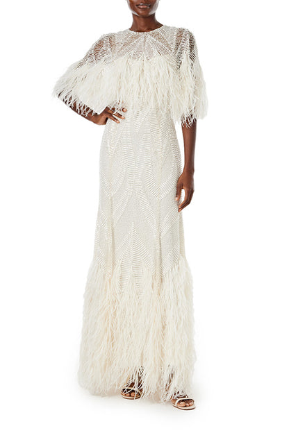 Monique Lhuillier Spring 2024 embroidered capelet gown with feathered trim.