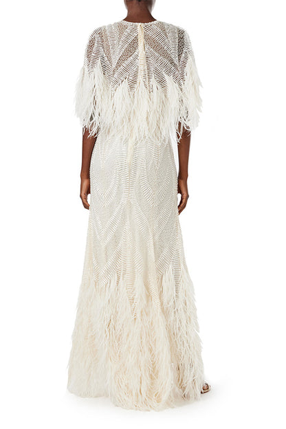 Monique Lhuillier Spring 2024 embroidered capelet gown with feathered trim.