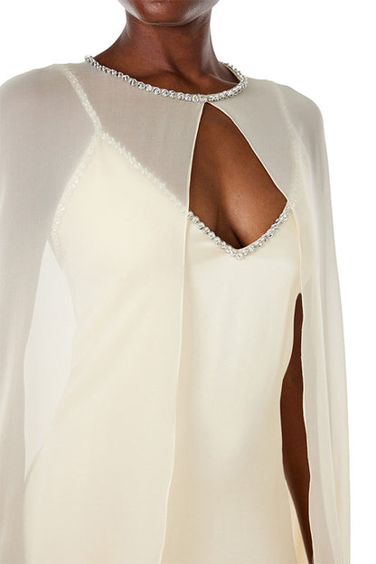 Monique Lhuillier creme chiffon cape with crystal neckline over satin slip gown.