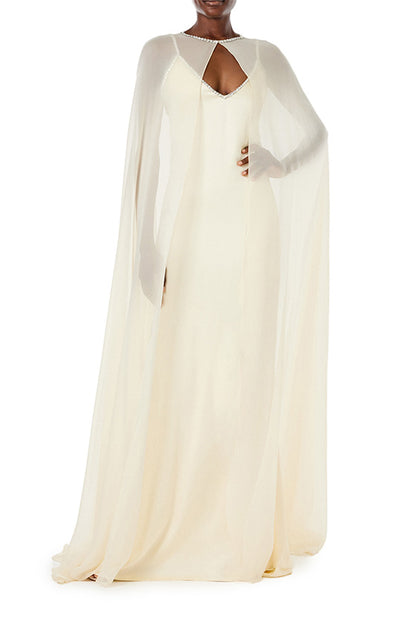 Monique Lhuillier creme chiffon cape with crystal neckline over satin slip gown.