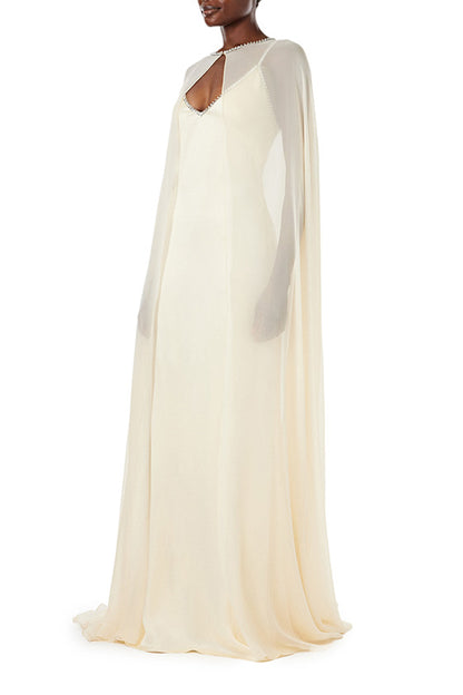 Monique Lhuillier creme chiffon cape with crystal neckline over satin slip gown.