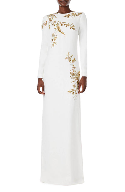 Monique Lhuillier silk white jewel neck, long sleeve column gown with gold embroidery.