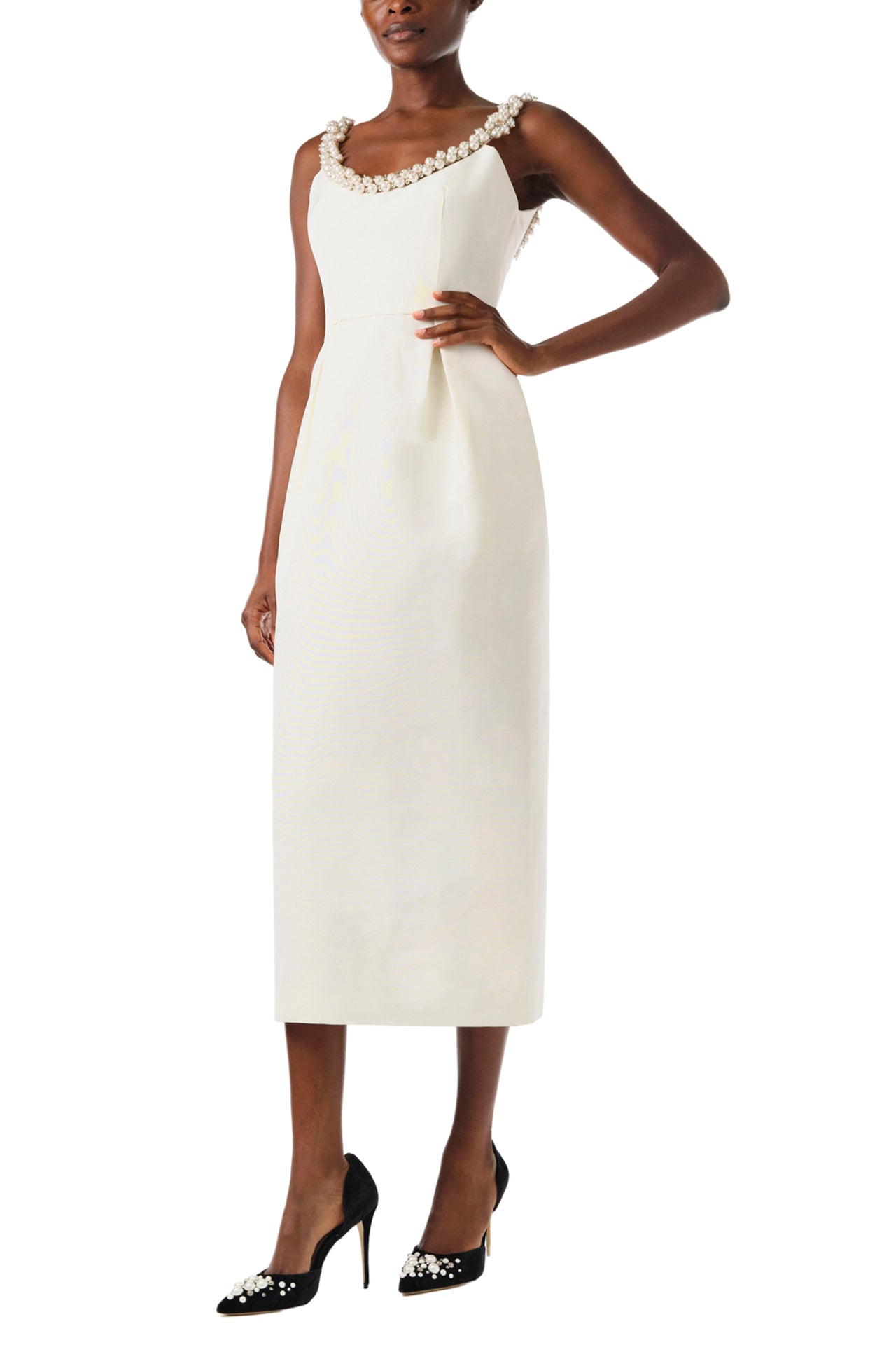 Monique Lhuillier Fall 2024 sleeveless, scoop neck cocktail dress with pearl embroidered neckline, low back, pockets, and natural waist seam - left side.