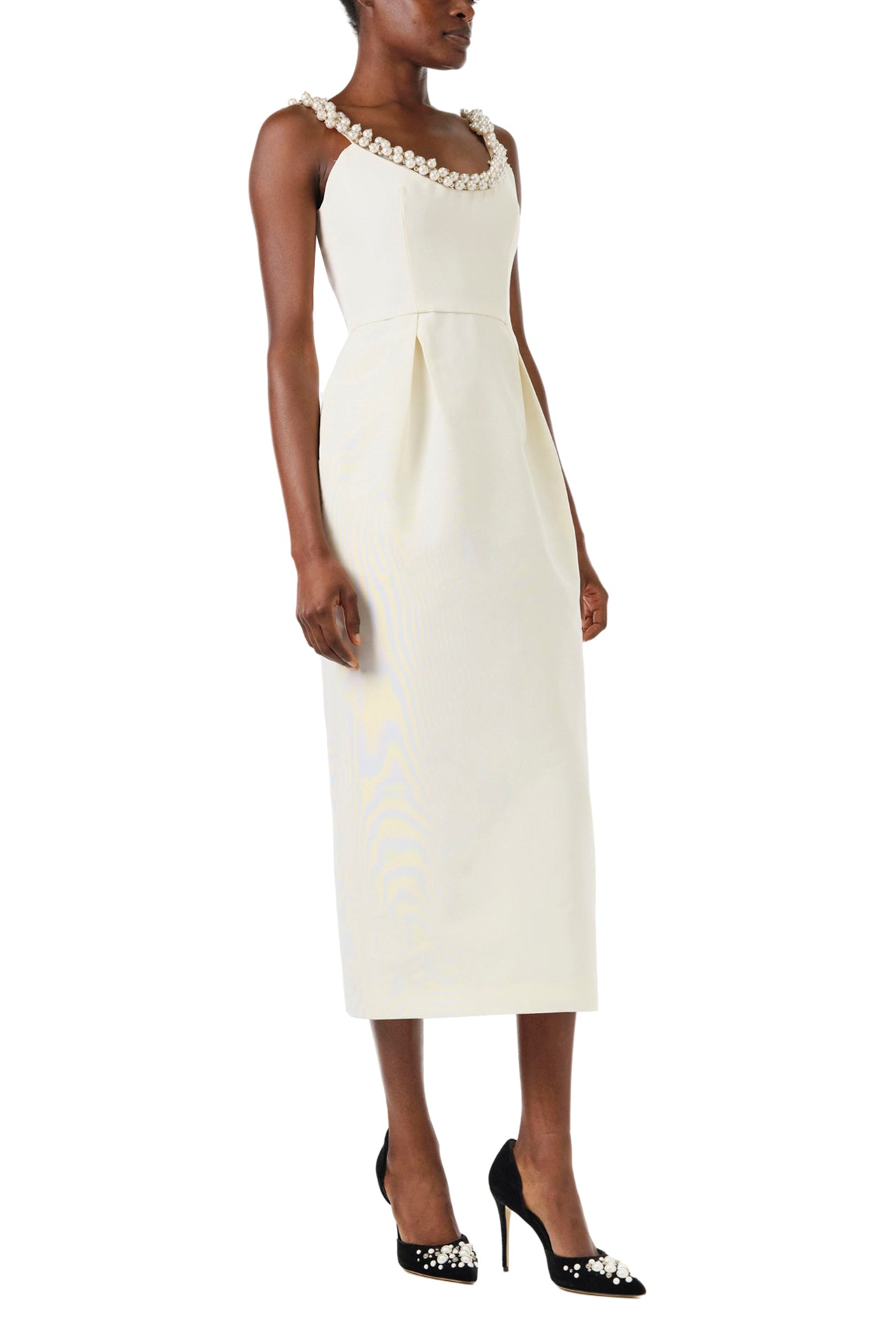Monique Lhuillier Fall 2024 sleeveless, scoop neck cocktail dress with pearl embroidered neckline, low back, pockets, and natural waist seam - left side.
