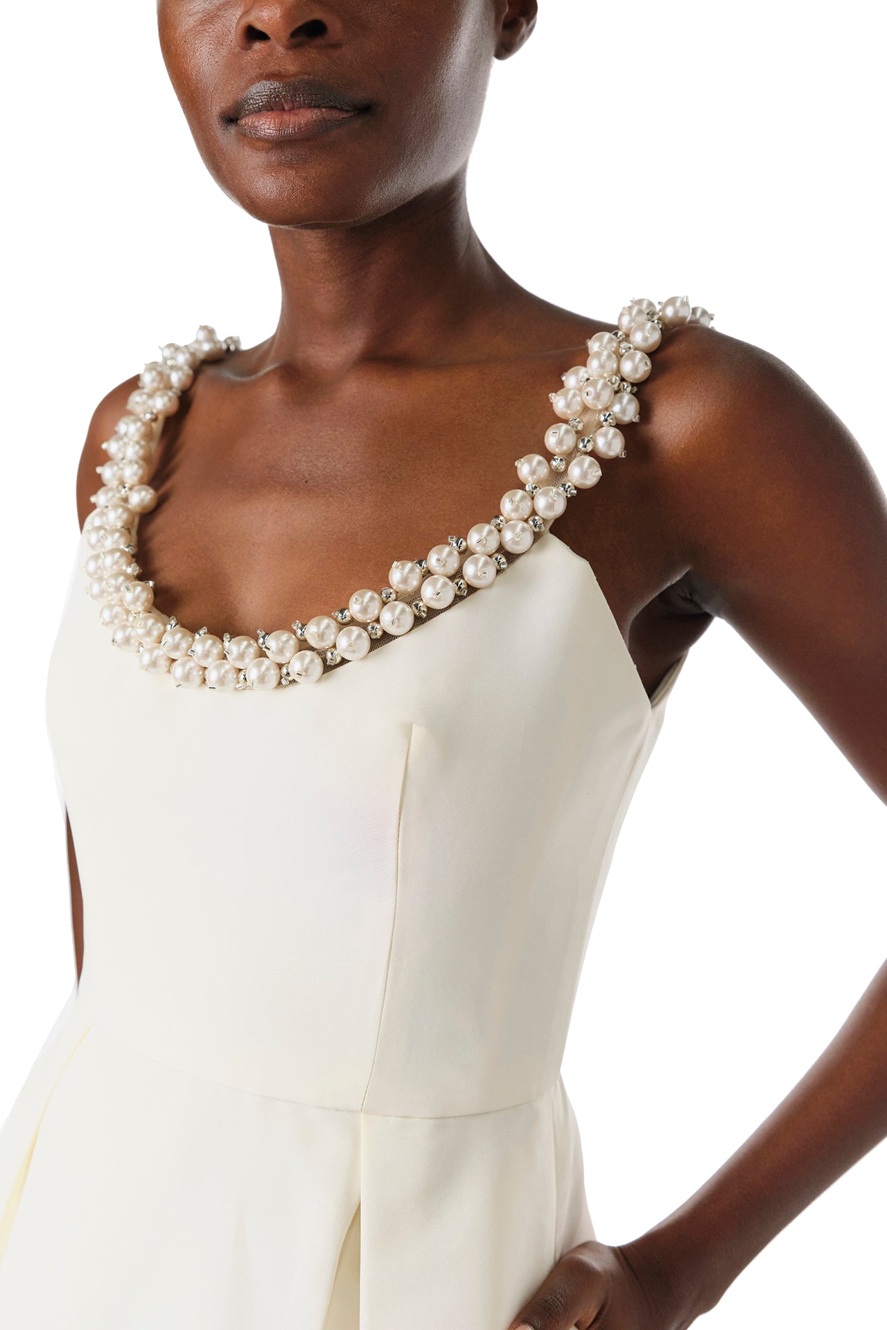 Monique Lhuillier Fall 2024 sleeveless, scoop neck cocktail dress with pearl embroidered neckline, low back, pockets, and natural waist seam - pearl detail.