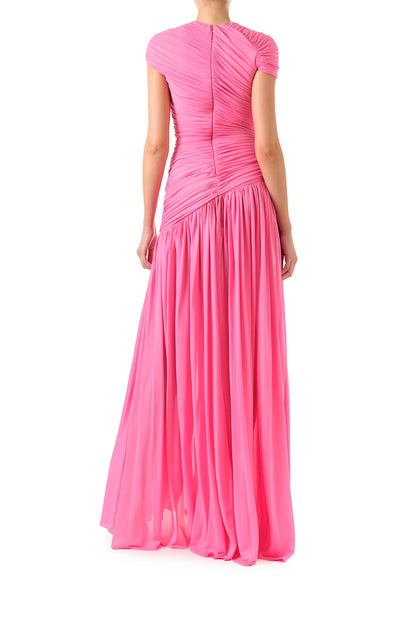 Monique Lhuillier Fall 2024 draped, asymmetric gown with drop waist, cap sleeves and front leg slit in pink crepe jersey fabric - back.