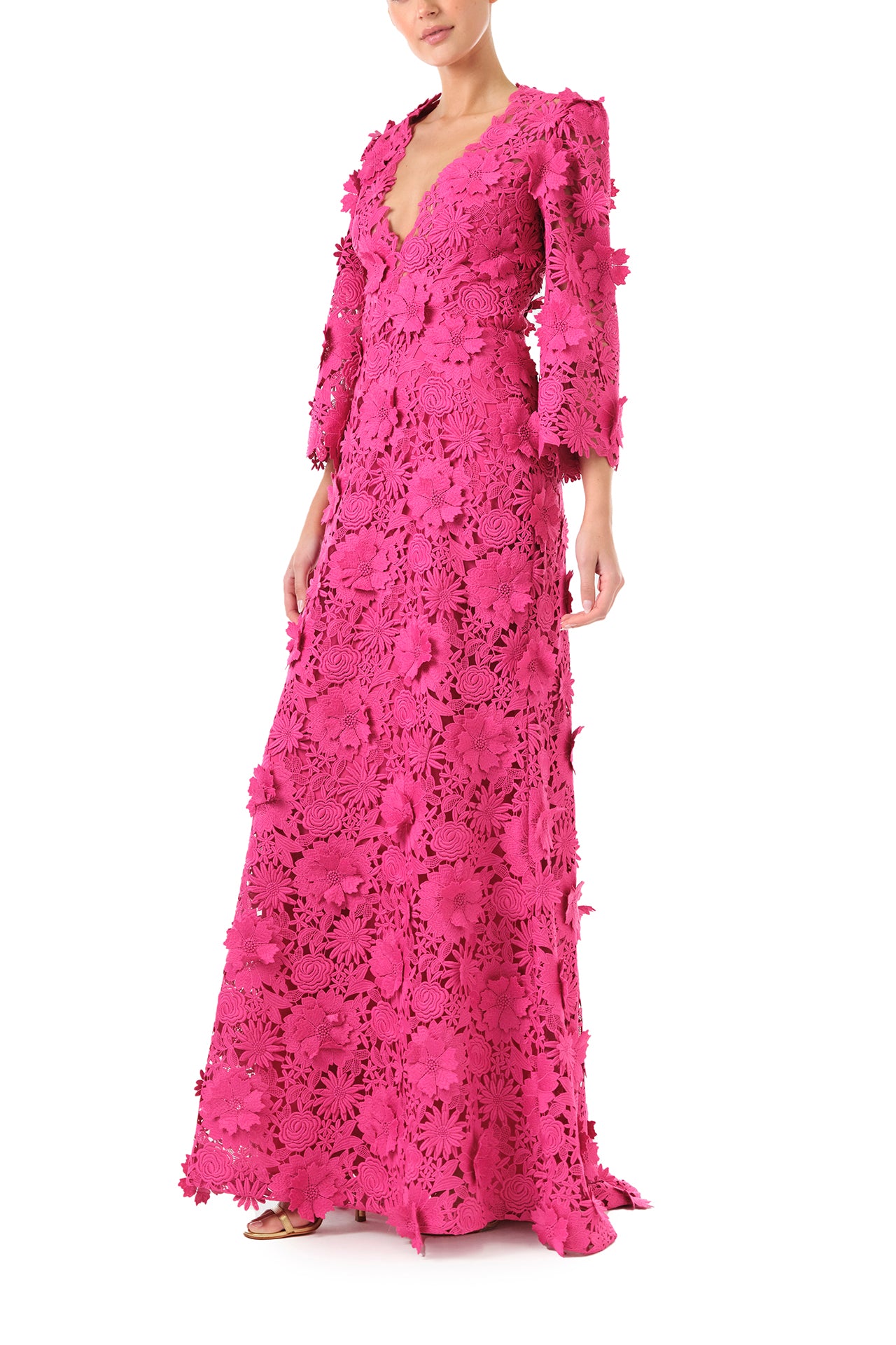 Monique Lhuillier Fall 2024 bell sleeve, floor length gown with deep v-neckline in Fuchsia 3D Guipure Lace - left side.