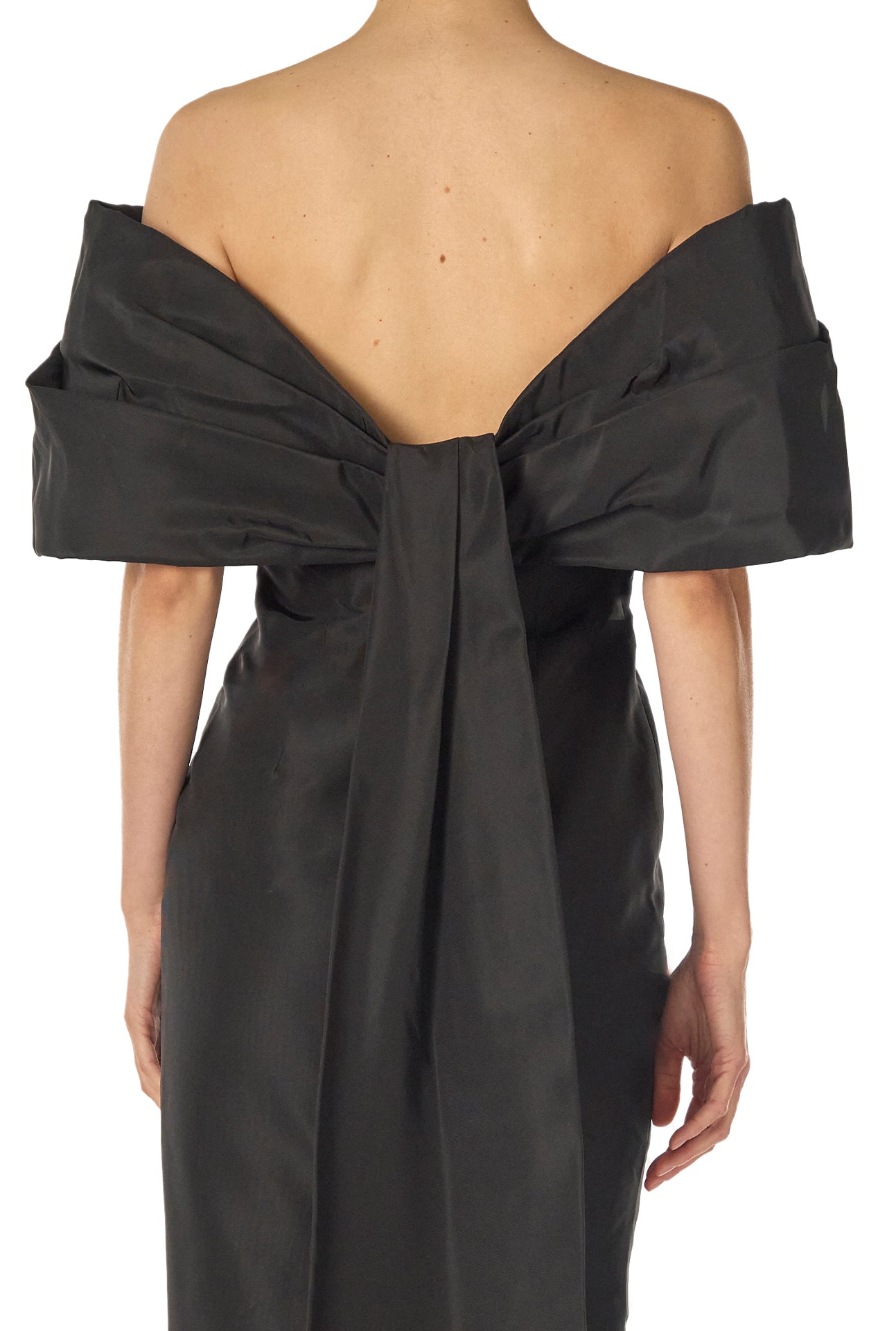 Monique Lhuillier Fall 2024 Off-the-shoulder tea length column dress with draped neckline and train in noir silk faille - back bow detail.