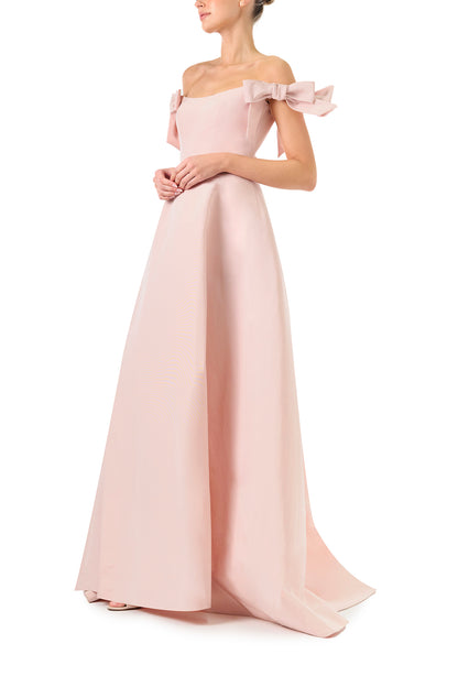 Monique Lhuillier Fall 2024 off the shoulder bow sleeve gown in pale blush faille with full skirt and high leg slit - side.