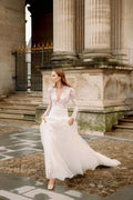 Woman wearing Monique Lhuillier Fall 2023 Bliss long sleeve v-neck white embroidered tulle a-line BL23203 gown