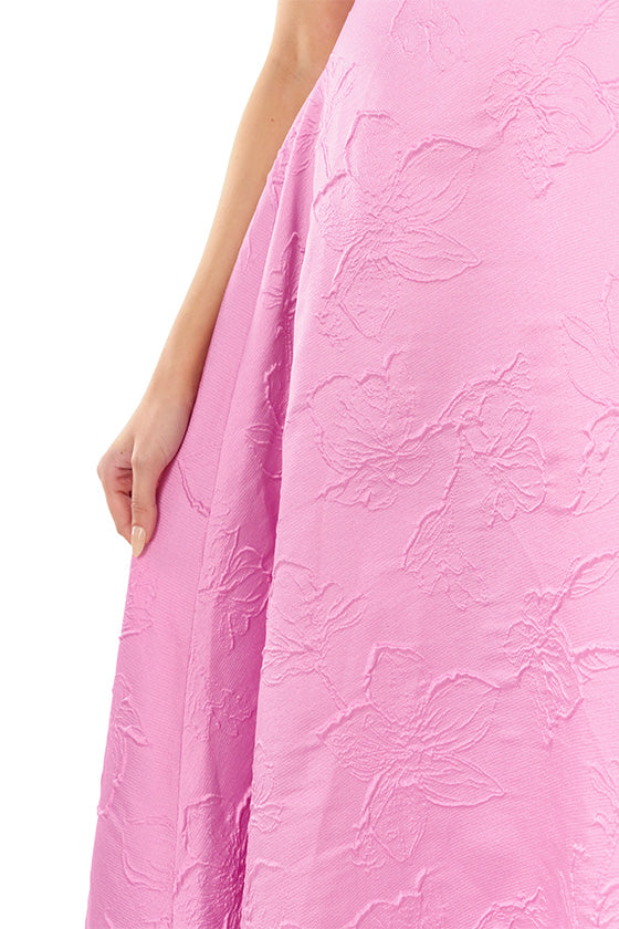 ML Monique Lhuillier floor length dress in orchid jacquard fabric with one shoulder and bow neckline.