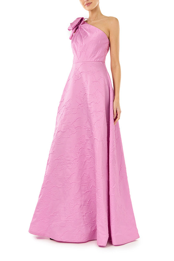 ML Monique Lhuillier floor length dress in orchid jacquard fabric with one shoulder and bow neckline.