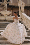 Woman wearing Monique Lhuillier Spring 2023  Bliss white and multi colored floral print strapless organza BL23102 ballgown