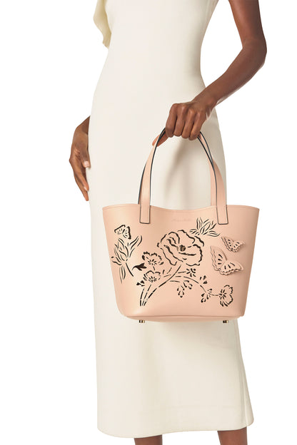 Leather top handle tote bag with laser cut florals, three-dimensional leather butterflies and small zip pouch in Blush- modeled