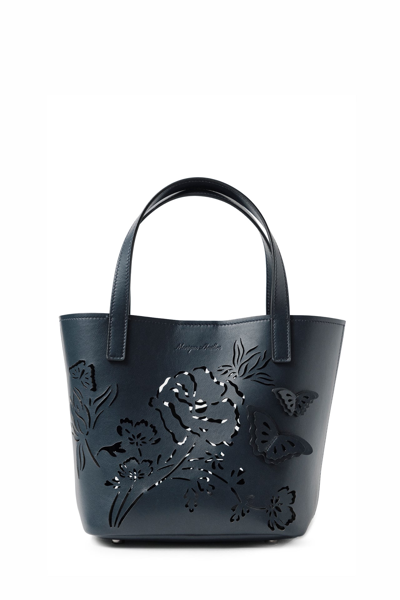 Leather top handle mini tote bag with laser cut florals, three-dimensional leather butterflies and small zip pouch in Navy- front