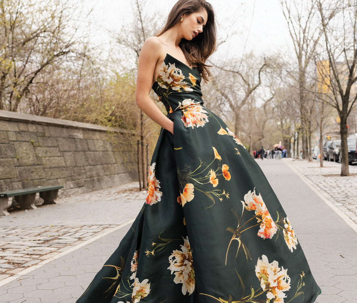 Monique Lhuillier Fall 2024 dark green and floral print ball gown on model on street 