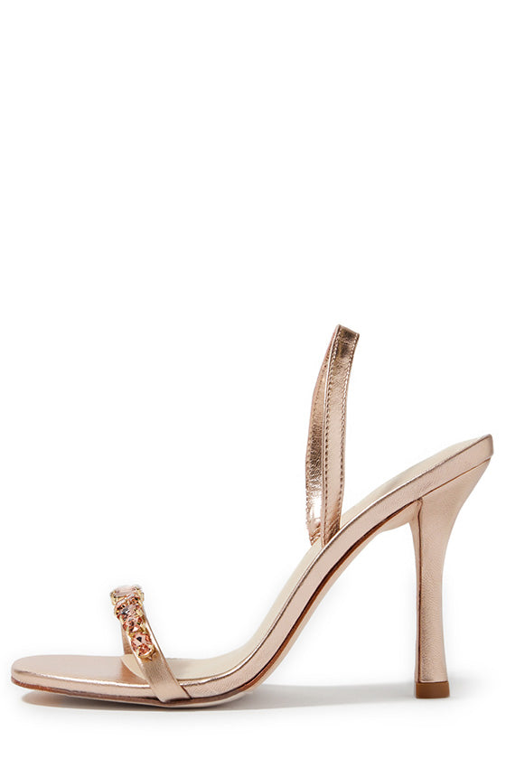 Monique Lhuillier Kirby heel in rose gold metallic leather with rhinestone toe strap and slingback.