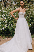 Woman wearing Monique Lhuillier Spring 2023  Bliss white strapless embroidered lace BL23105 ballgown