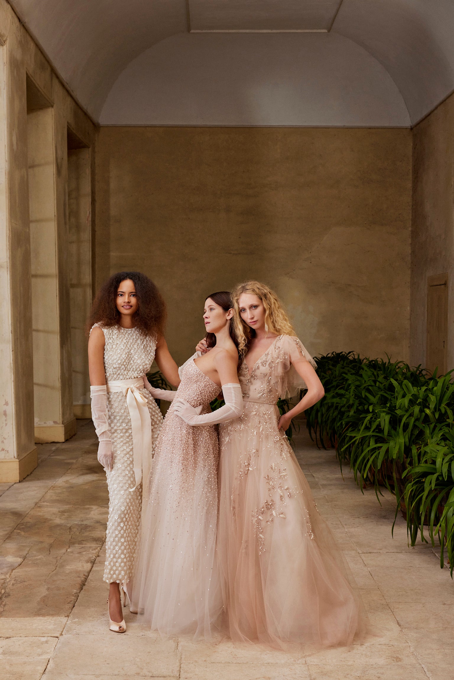 Monique Lhuillier Fall 2024 strapless, A-line tulle gown in Pale Blush with cascading pearl embroidery - lookbook photo of 3 gowns.