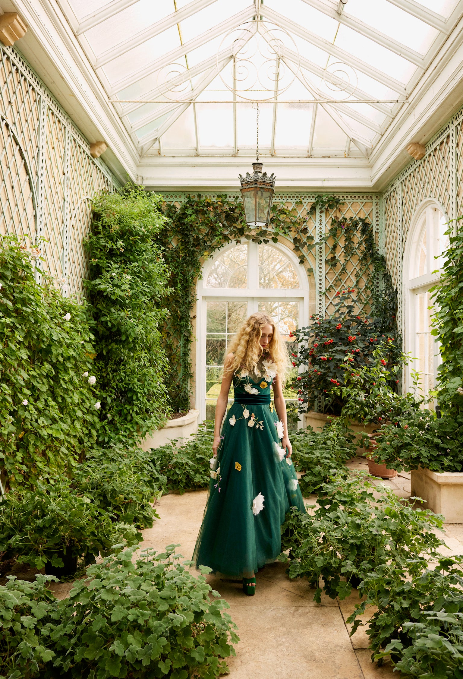 Monique Lhuillier Fall 2024 sleeveless, green tulle gown with floral embroidery, illusion neckline, full A-line skirt and velvet cummerbund at waist - lookbook.