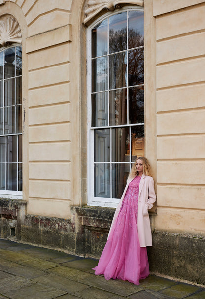 Monique Lhuillier Fall 2024 Dahlia pink, embroidered tulle flutter sleeve gown with jewel neckline - look book with creme wool coat.