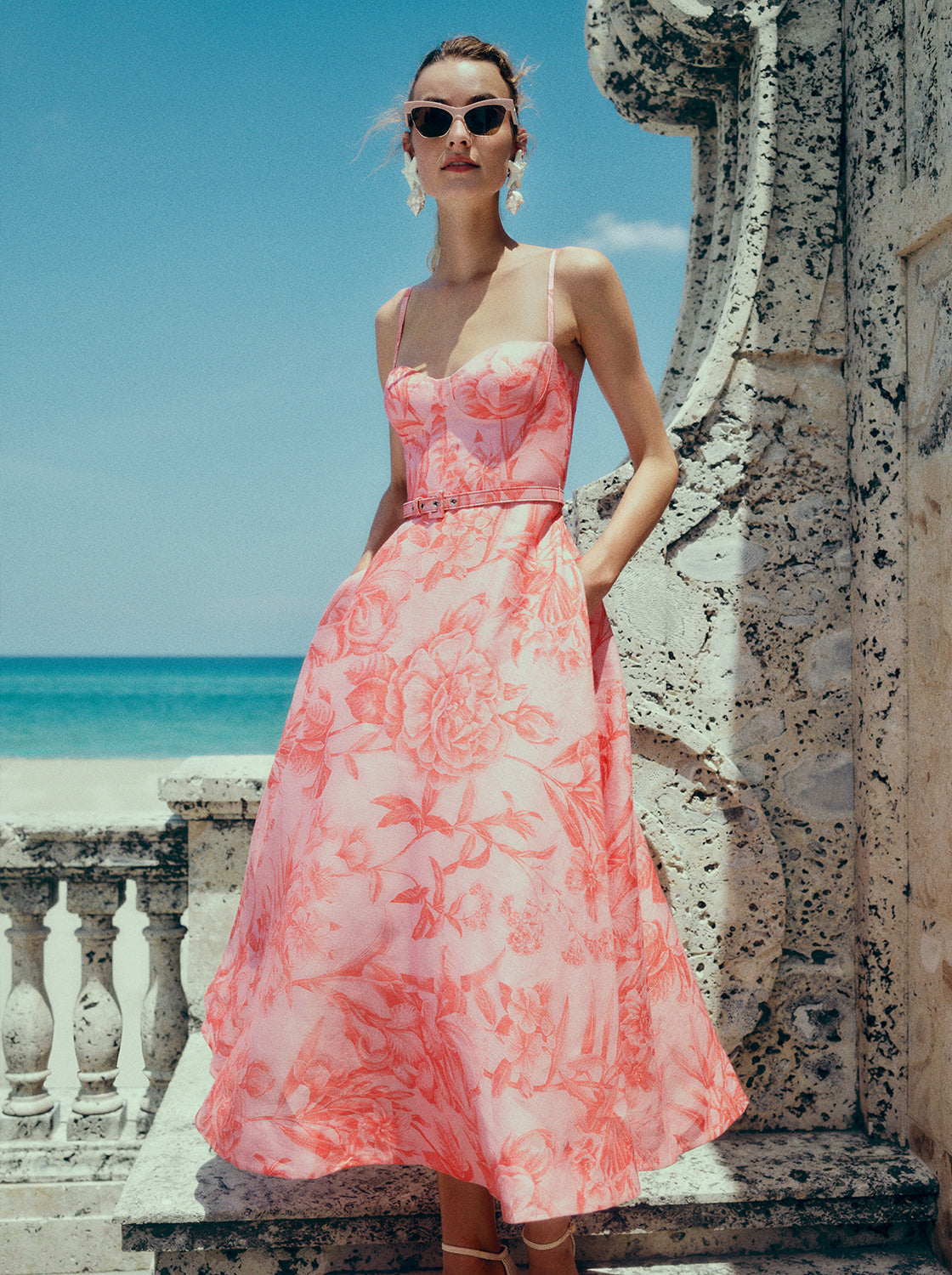 Monique Lhuillier Spring 2025 rosette coral corseted midi dress.