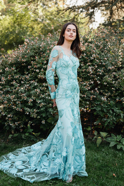 Monique Lhuillier Spring 2025 Embroidered, aqua floral tulle long sleeve trumpet gown with jewel neckline - lookbook photo on model.