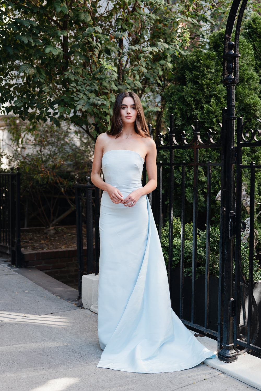 Monique Lhuillier Spring 2025 Strapless, draped column gown with attached train in Powder Blue faille fabric - lookbook one.