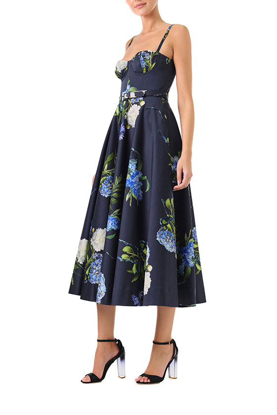 Monique Lhuillier Fall 2024 blue floral spaghetti strap, a-line midi dress with corseted bodice, pockets and belted waist - left side.