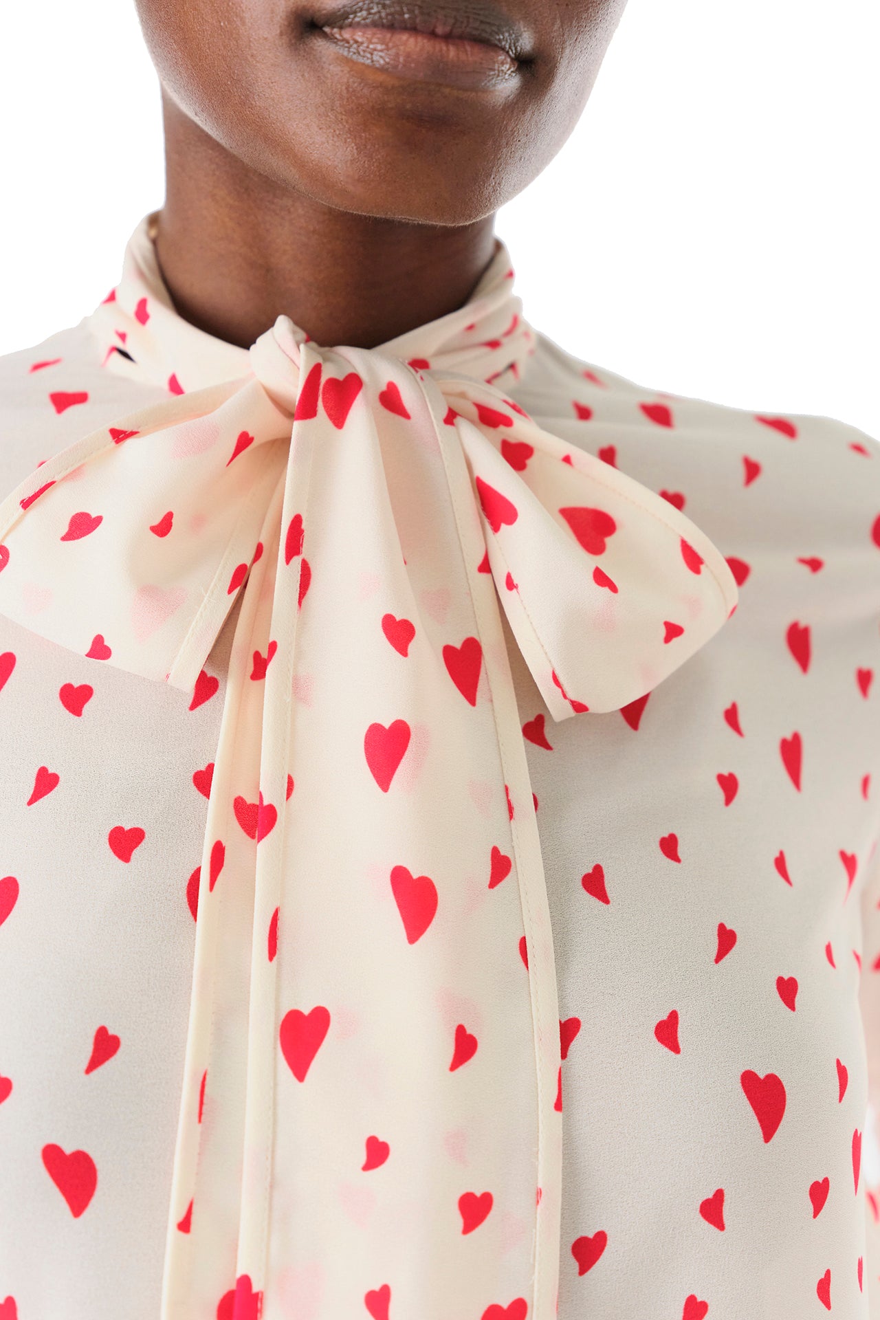 Monique Lhuillier Fall 2024 long sleeve, bow tie blouse in Heart Printed Georgette - bow tie detail.