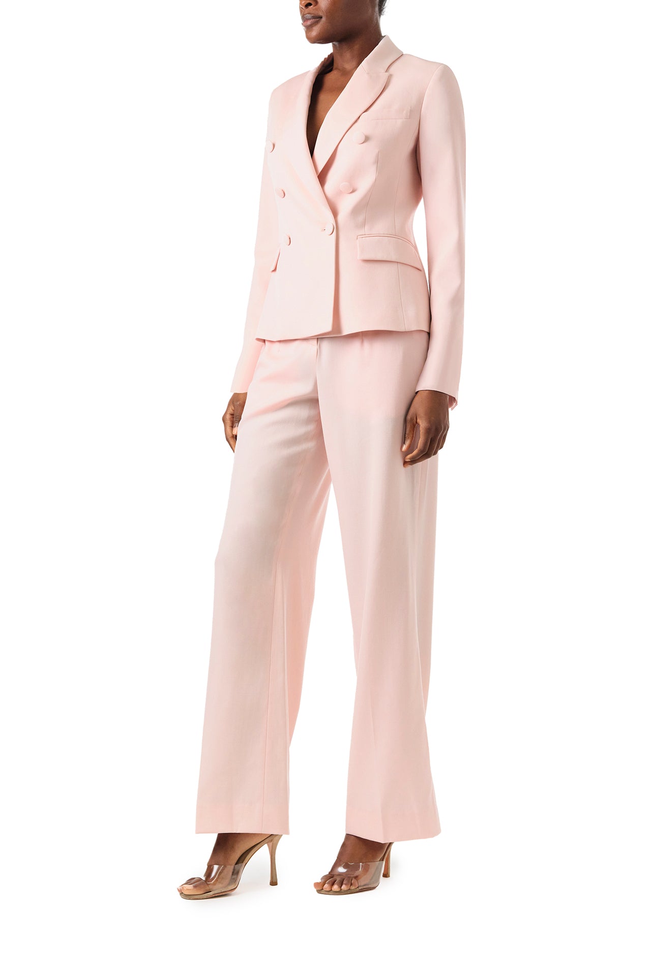 Monique Lhuillier Fall 2024 pale blush wool, double breasted wool blazer with full length sleeve - left side.