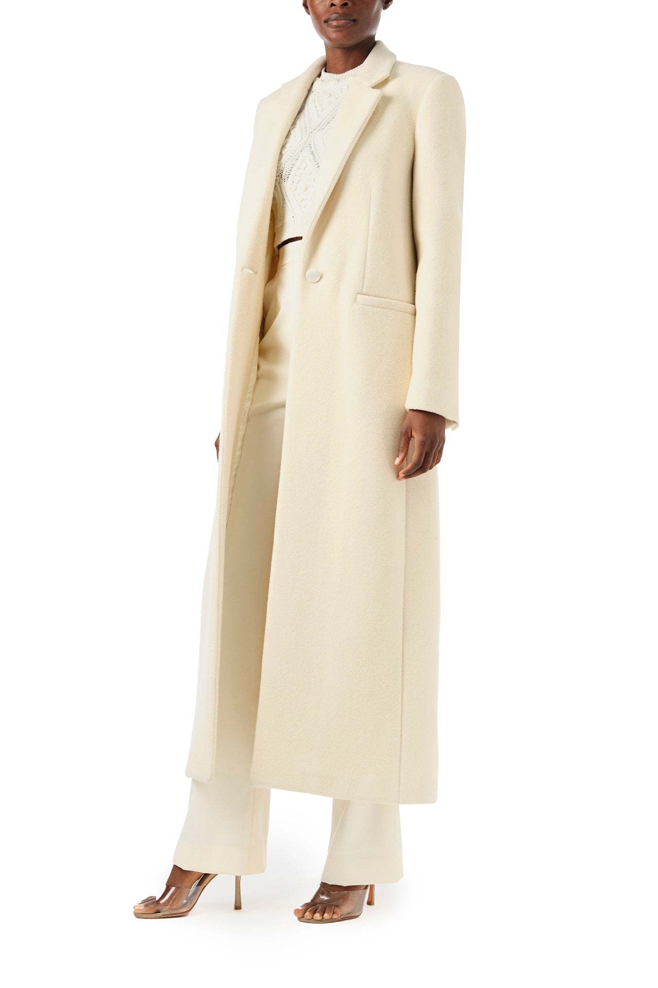 Monique Lhuillier Fall 2024 long sleeve coat in creme colored wool and single closure button - left side.