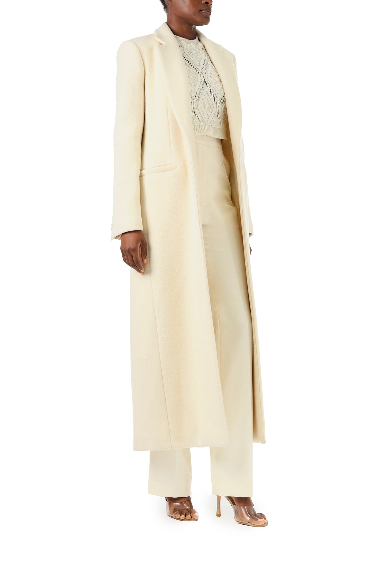 Monique Lhuillier Fall 2024 long sleeve coat in creme colored wool and single closure button - right side.
