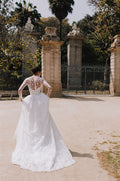 Woman wearing Monique Lhuillier Spring 2023  Bliss white strapless embroidered BL23105 ballgown with matching embroidered BL23170 jacket