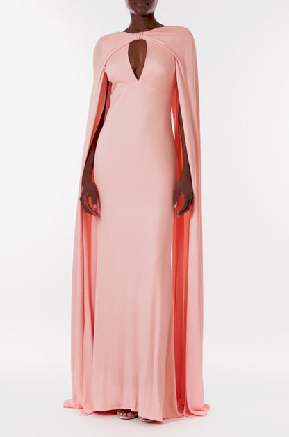 Monique Lhuillier melon colored crepe-back satin gown with attached cape and keyhole bodice.