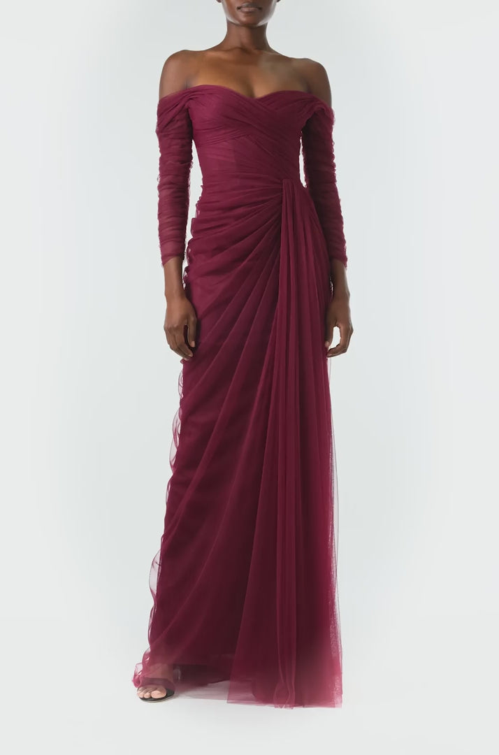 Monique Lhuillier Fall 2024 Off the shoulder draped tulle gown with low V-back, long sleeves and corseted bodice in Merlot - video.