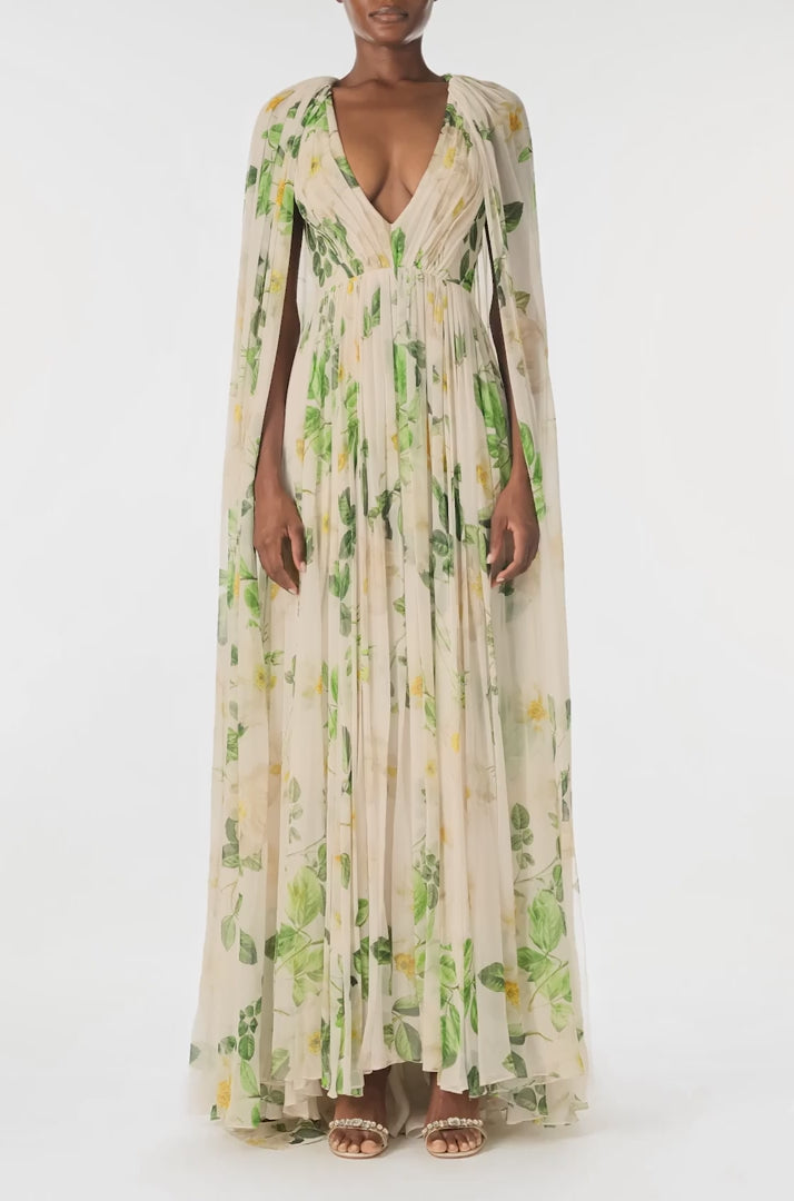 Monique Lhuillier Spring 2025 Draped, v-neck gown in Rose Printed Chiffon with low back and flowing, integral cape - video.