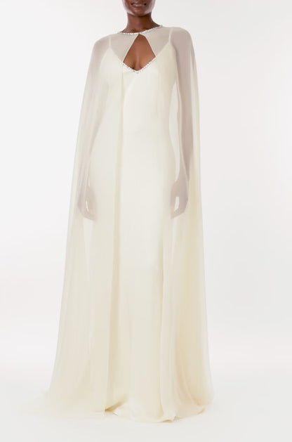 Monique Lhuillier creme chiffon cape with crystal neckline over satin slip gown.